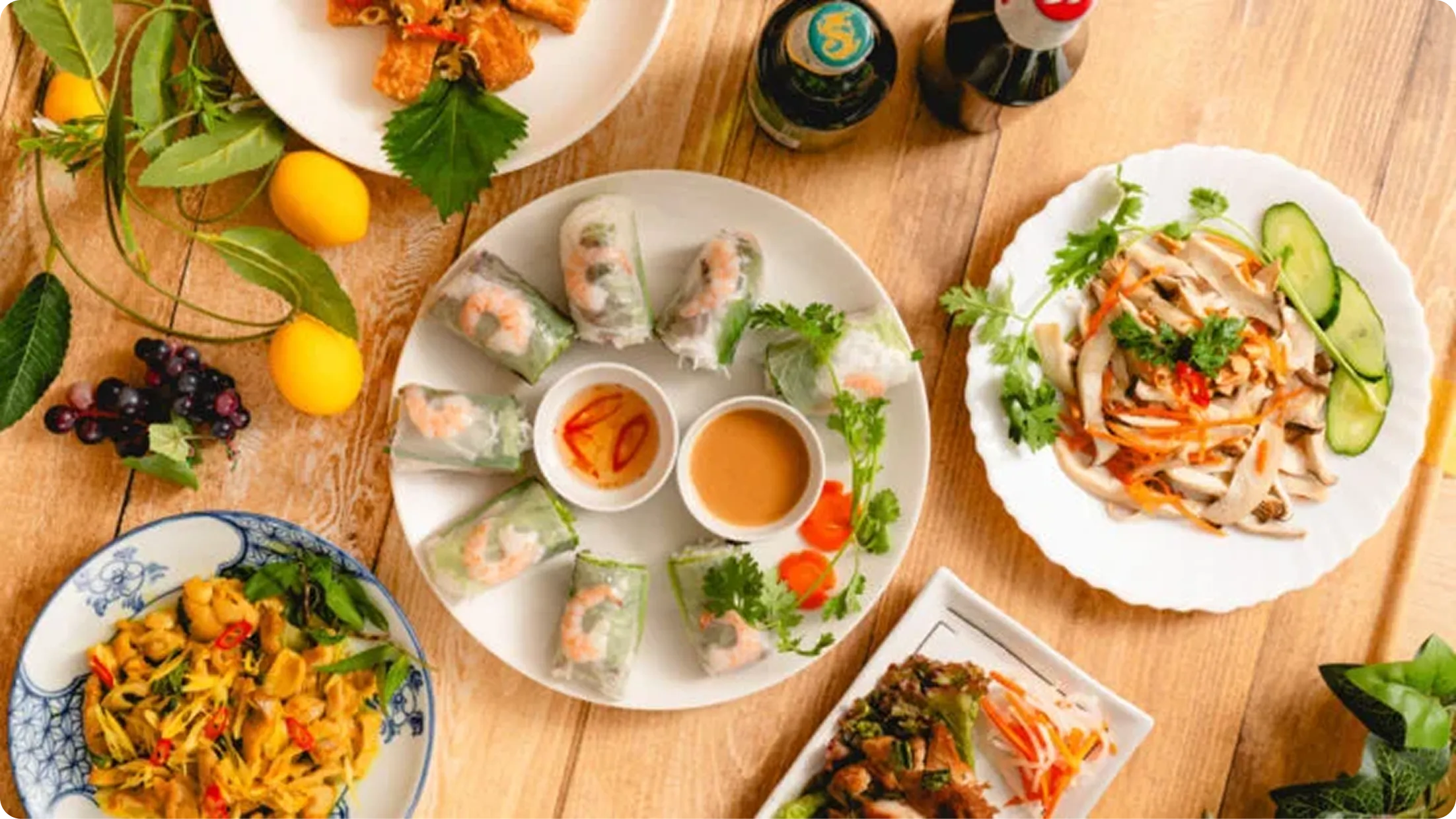 An assortment of small dishes and spring rolls